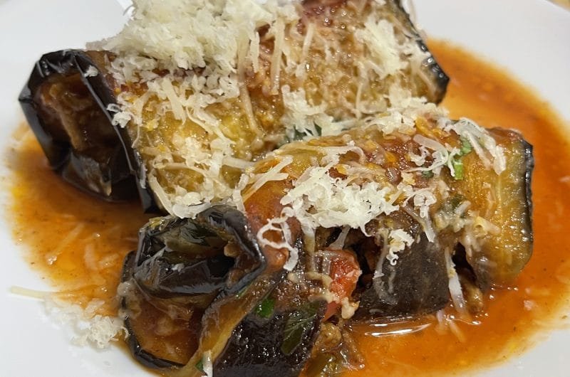 Baked eggplant rolls stuffed with beef in tomato sauce