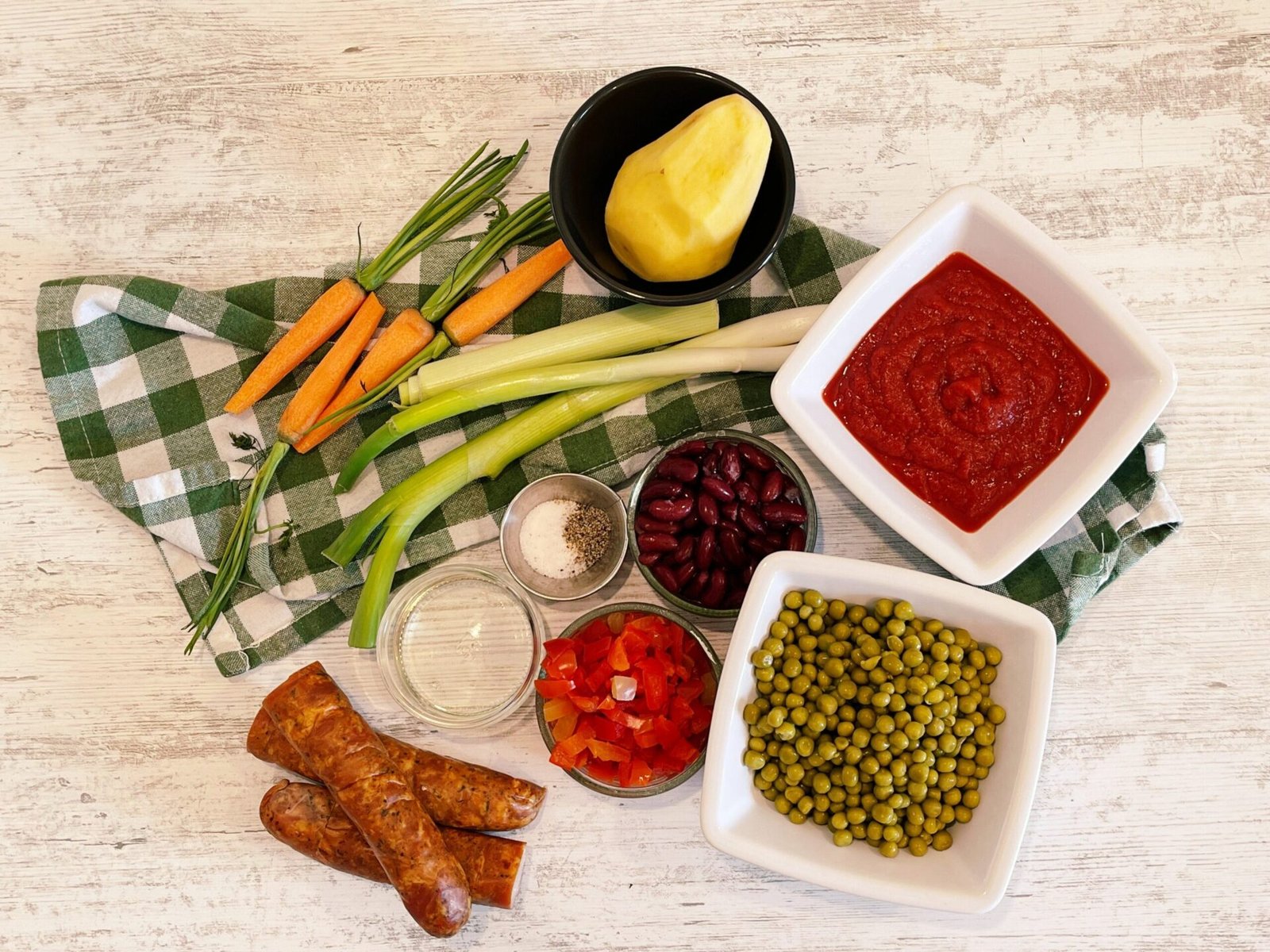 ingredients Delicious Peas and Vegetable Stew with Smoked Sausages in Fiery Red Tomato Sauce