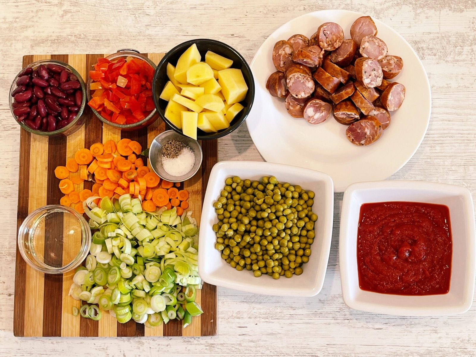 prep ingredients Delicious Peas and Vegetable Stew with Smoked Sausages in Fiery Red Tomato Sauce